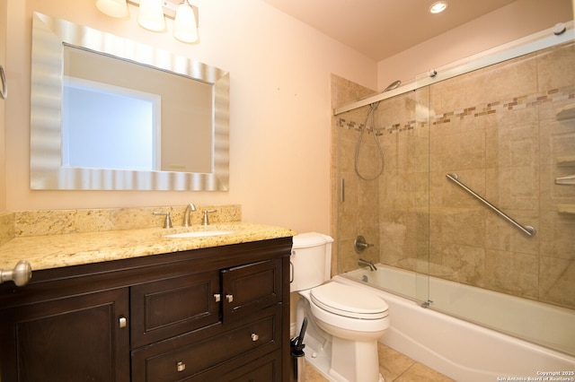 full bath featuring vanity, tile patterned floors, toilet, and enclosed tub / shower combo