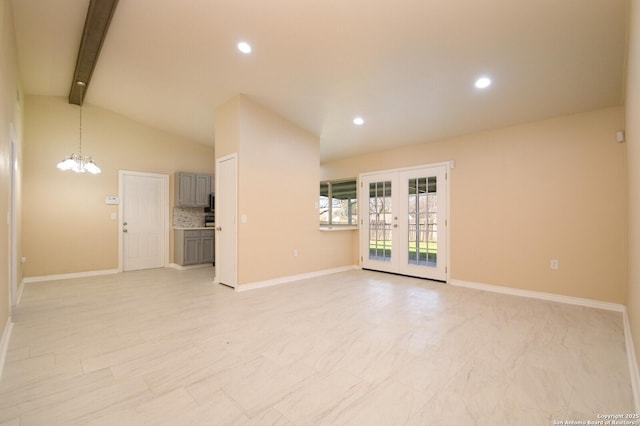 empty room with lofted ceiling with beams, recessed lighting, french doors, and a chandelier