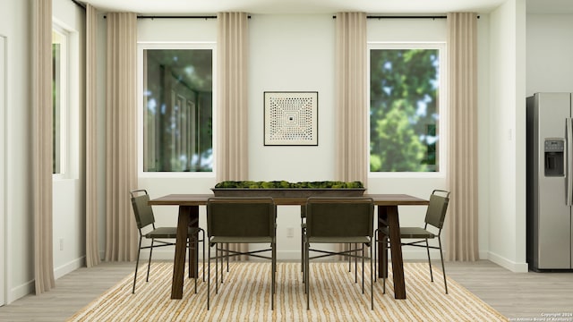 dining space featuring breakfast area, baseboards, and wood finished floors