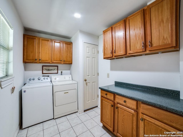 laundry area with light tile patterned floors, cabinet space, and independent washer and dryer