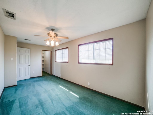 unfurnished bedroom with visible vents, carpet flooring, baseboards, and a ceiling fan