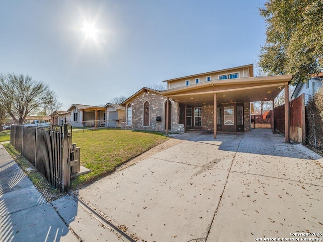 view of front of house with a front yard, fence, brick siding, and driveway