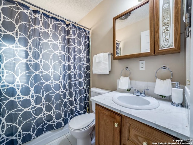 bathroom with vanity, a shower with shower curtain, toilet, and a textured ceiling