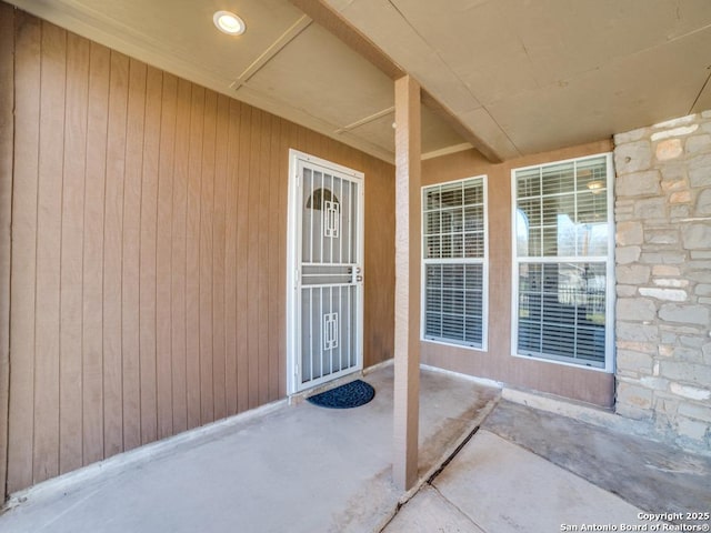 doorway to property featuring stone siding