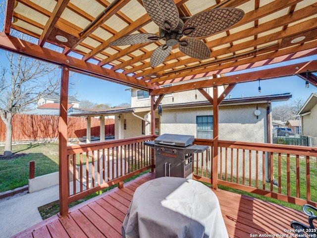 wooden terrace featuring grilling area, a yard, and fence