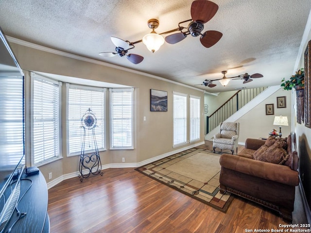 living area featuring stairway, wood finished floors, and ornamental molding