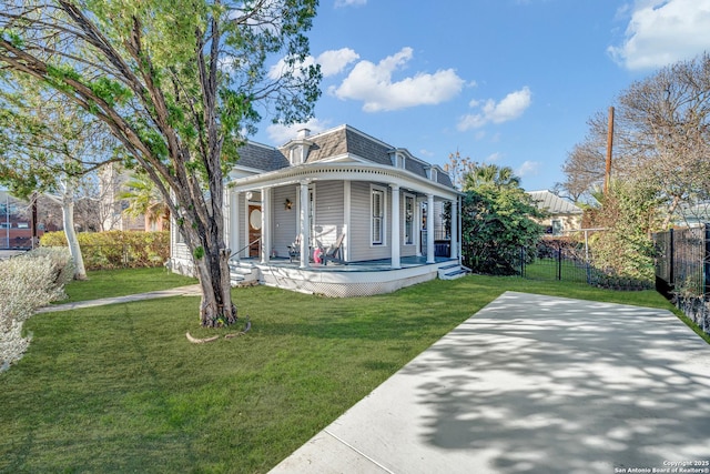 victorian home featuring a front lawn, mansard roof, a porch, fence, and roof with shingles