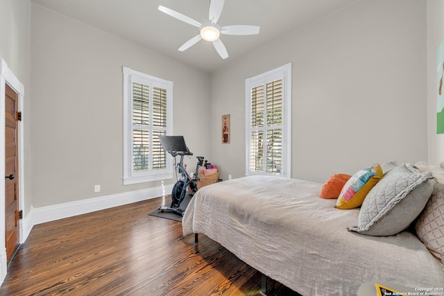 bedroom featuring ceiling fan, baseboards, and wood finished floors