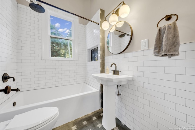 full bathroom with tile walls, toilet, and tub / shower combination