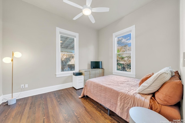 bedroom featuring a ceiling fan, dark wood-type flooring, and baseboards