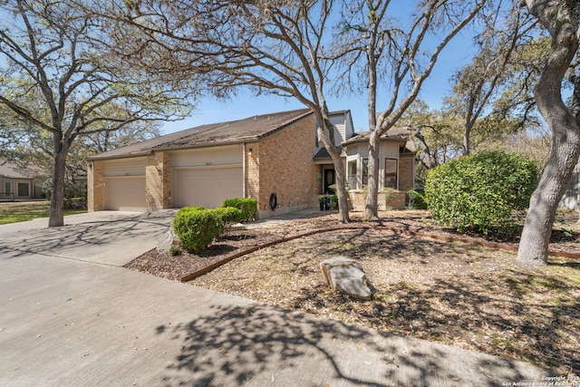 view of front of house featuring brick siding, concrete driveway, and a garage