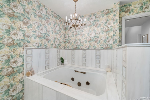 full bath with wallpapered walls, a tub with jets, and a chandelier