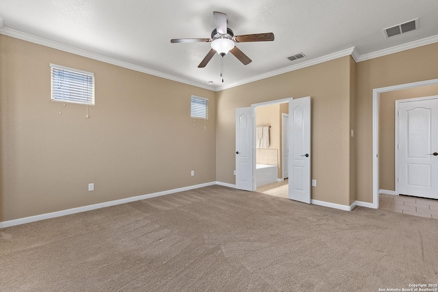 unfurnished bedroom with visible vents, light carpet, multiple windows, and ornamental molding