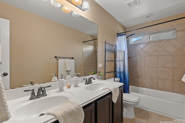 bathroom with visible vents, toilet, a sink, shower / tub combo, and tile patterned flooring