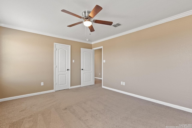 unfurnished bedroom featuring visible vents, ornamental molding, a ceiling fan, carpet flooring, and baseboards