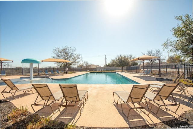 pool featuring a patio and fence