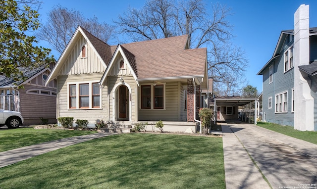 view of front of home featuring driveway, a shingled roof, a front lawn, a carport, and board and batten siding