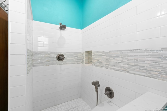 full bath with a tile shower