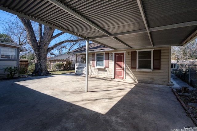 view of patio with a carport and fence