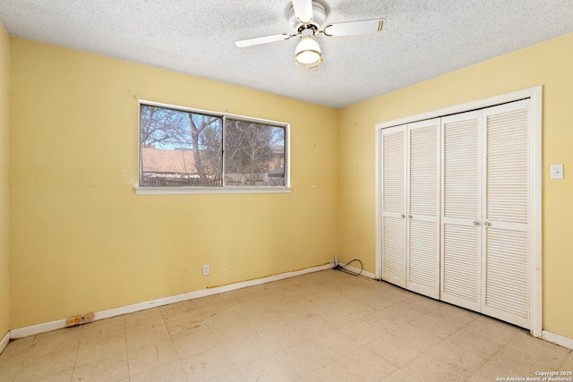 unfurnished bedroom featuring tile patterned floors, a closet, baseboards, and a textured ceiling