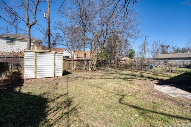 view of yard with a fenced backyard, a storage shed, and an outdoor structure