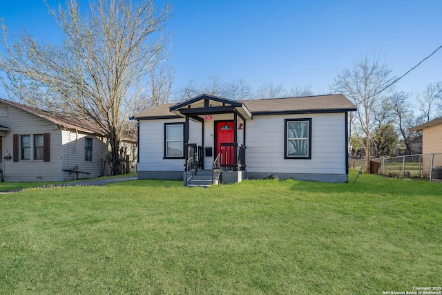 bungalow-style home featuring a front yard and fence