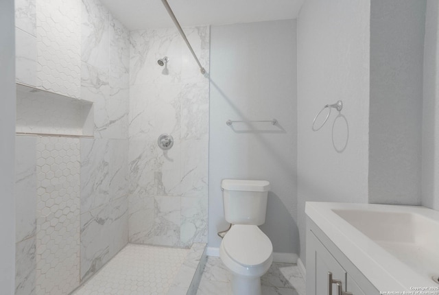 full bath featuring baseboards, toilet, a tile shower, marble finish floor, and vanity