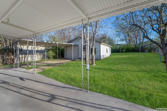 view of front of property with a front yard, a carport, and an outdoor structure