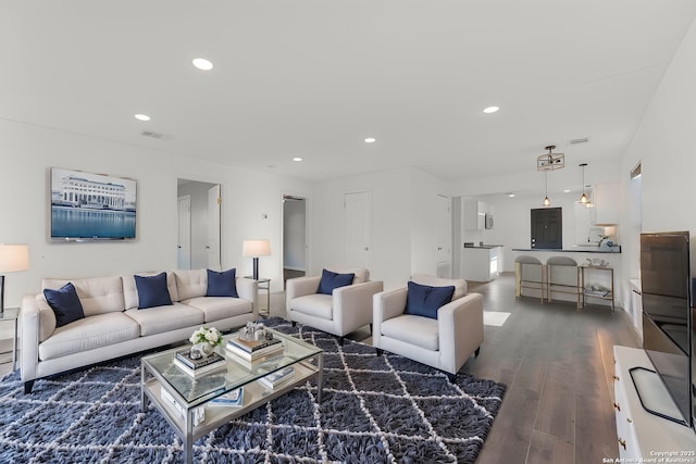 living area featuring recessed lighting, visible vents, and dark wood-style floors