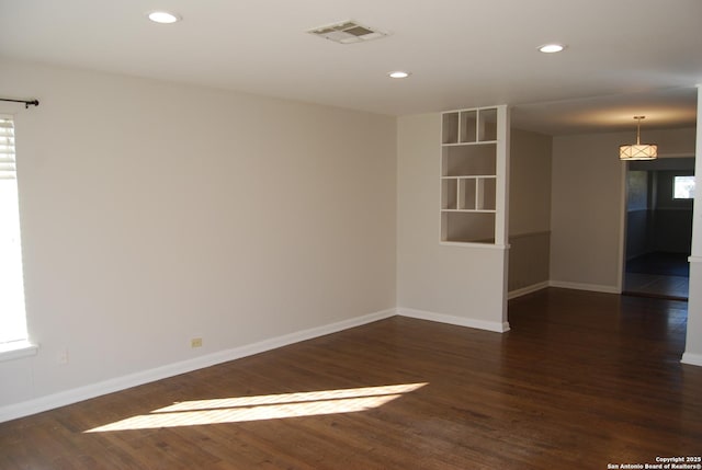 spare room featuring visible vents, recessed lighting, baseboards, and wood finished floors