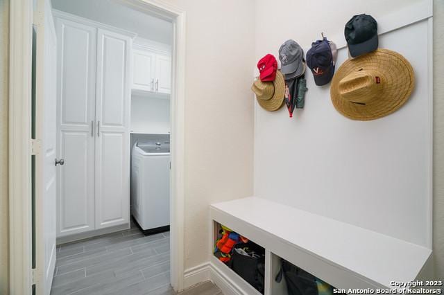 mudroom with washer / clothes dryer and wood finish floors