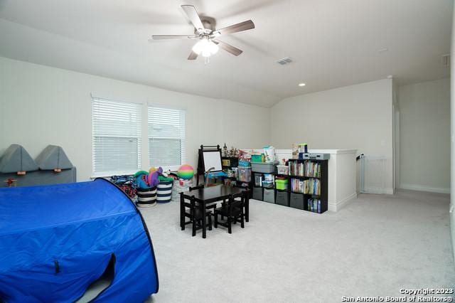 bedroom featuring visible vents, lofted ceiling, a ceiling fan, and carpet flooring