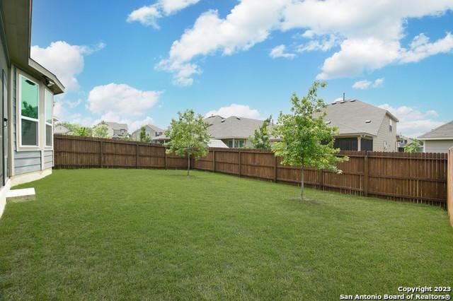 view of yard featuring a residential view and a fenced backyard