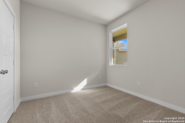 empty room with baseboards and carpet flooring