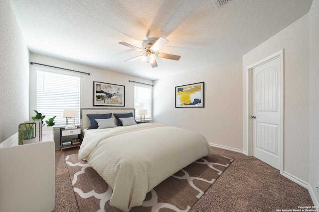 bedroom featuring carpet floors, a textured ceiling, and a textured wall