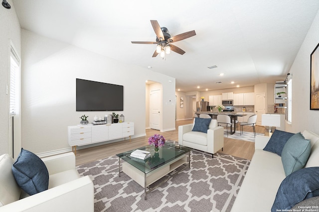 living room featuring recessed lighting, light wood-type flooring, baseboards, and ceiling fan