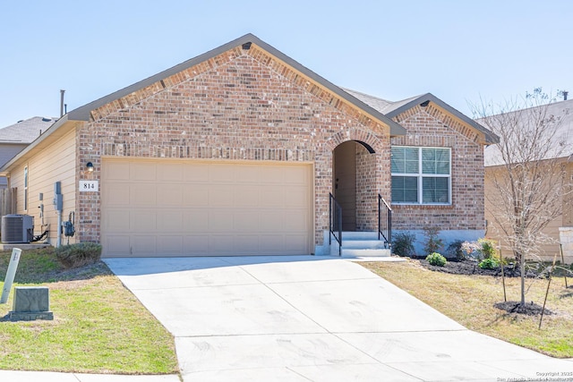 view of front facade featuring brick siding, central AC unit, an attached garage, and driveway