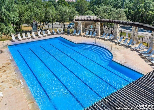 community pool featuring a patio and fence