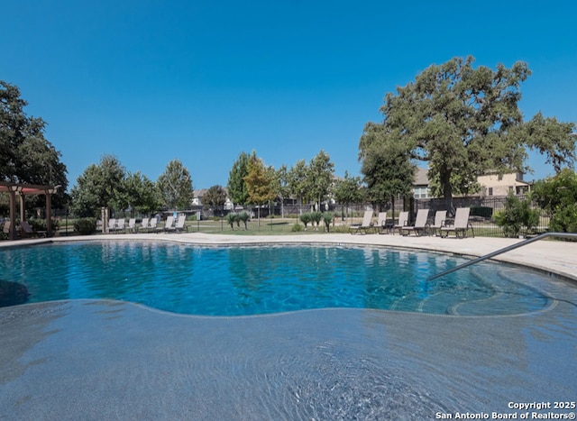 view of pool featuring a patio area and fence