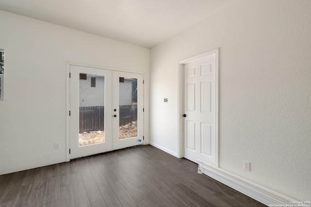 unfurnished room featuring french doors and dark wood-type flooring