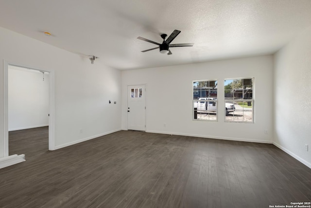 unfurnished living room featuring baseboards, a textured ceiling, dark wood finished floors, and a ceiling fan