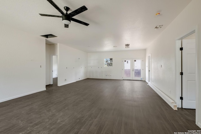 unfurnished living room with french doors, dark wood-type flooring, and ceiling fan