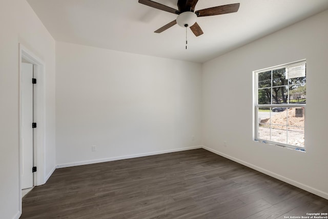 unfurnished room with baseboards, dark wood-type flooring, and ceiling fan