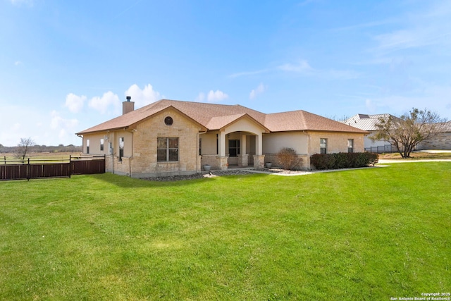 back of house with a lawn, a chimney, and fence