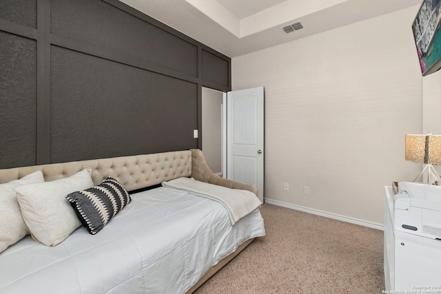 carpeted bedroom featuring visible vents and baseboards