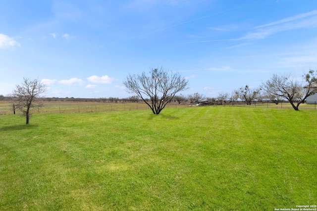 view of yard featuring a rural view and fence