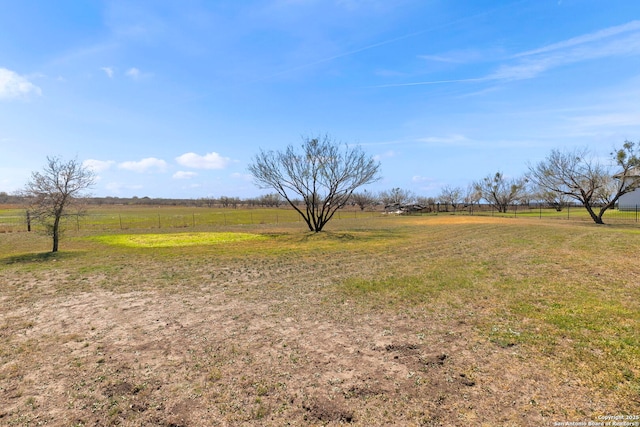 view of yard featuring a rural view and fence