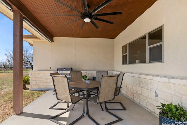 view of patio featuring outdoor dining area and a ceiling fan