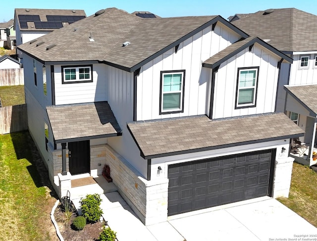 modern farmhouse with fence, driveway, roof with shingles, an attached garage, and board and batten siding