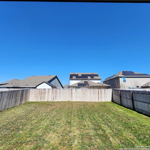 view of yard with a fenced backyard